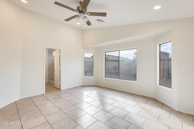 spare room with vaulted ceiling, ceiling fan, and light tile patterned flooring