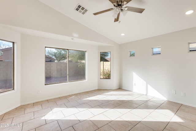 tiled empty room with a wealth of natural light, vaulted ceiling, and ceiling fan