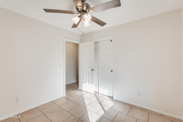 unfurnished bedroom featuring ceiling fan, a closet, and light tile patterned floors