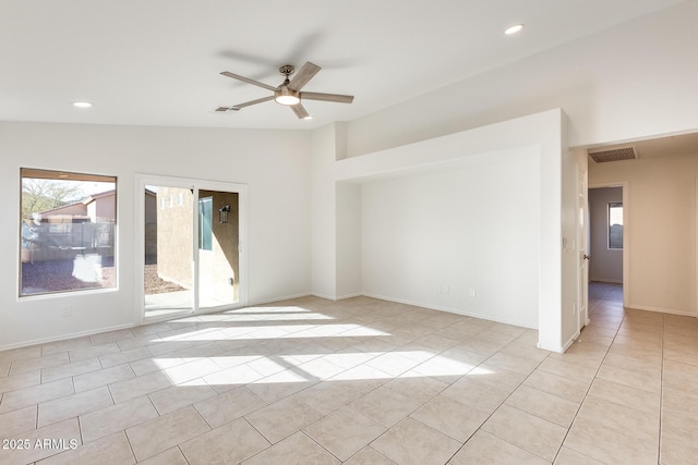 unfurnished room featuring light tile patterned flooring, ceiling fan, and lofted ceiling