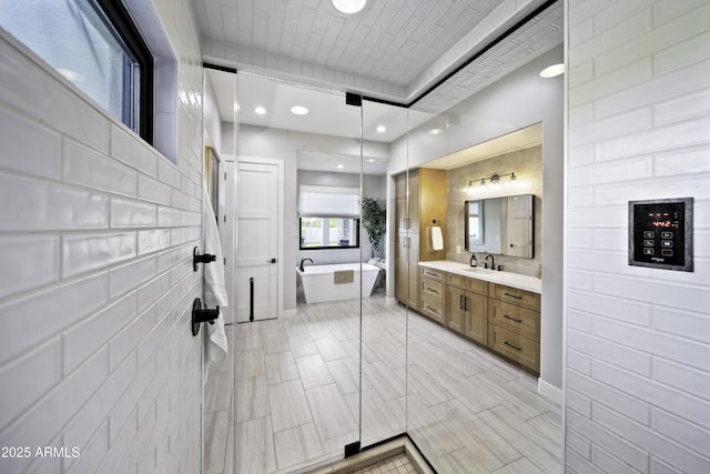 bathroom featuring vanity and a tub