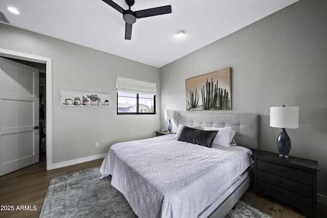 bedroom with ceiling fan and dark hardwood / wood-style flooring