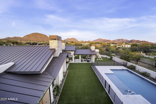 exterior space featuring a mountain view and a lawn