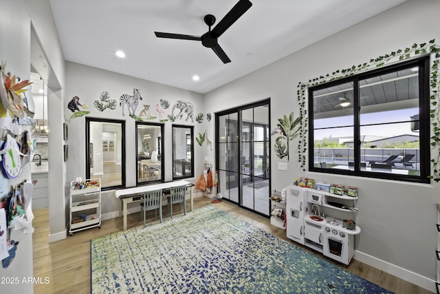 recreation room featuring hardwood / wood-style flooring and ceiling fan