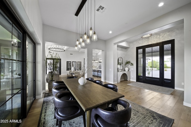 dining area featuring wood-type flooring and french doors