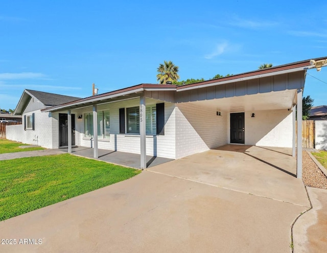 6805 N 12th St, Phoenix, AZ 85014 - view of front of property with a front yard, fence, a carport, and driveway