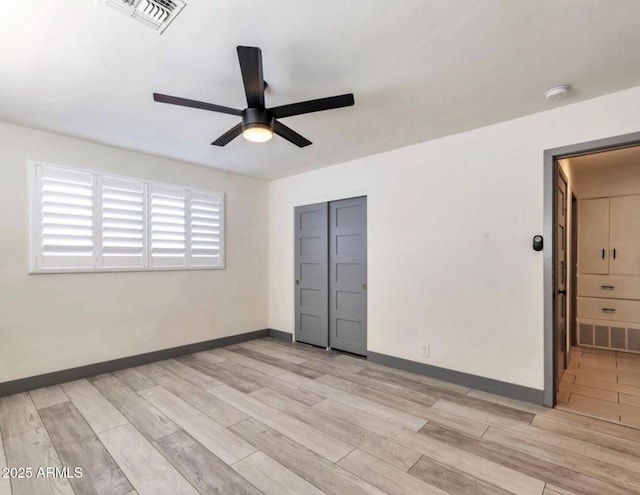 6805 N 12th St, Phoenix, AZ 85014 - unfurnished bedroom featuring light wood-style floors, baseboards, a ceiling fan, and visible vents