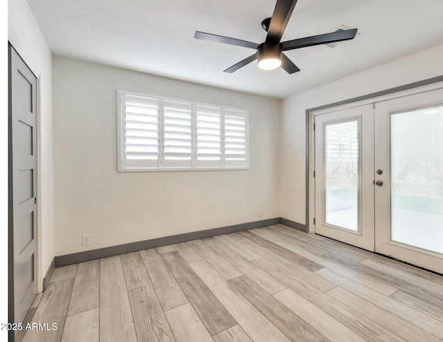 6805 N 12th St, Phoenix, AZ 85014 - spare room with light wood-type flooring, french doors, ceiling fan, and baseboards