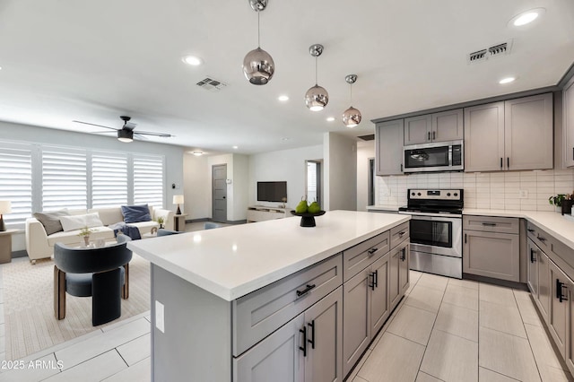 6805 N 12th St, Phoenix, AZ 85014 - kitchen featuring gray cabinets, visible vents, and stainless steel appliances
