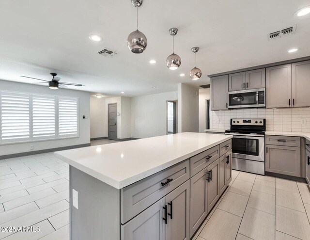 6805 N 12th St, Phoenix, AZ 85014 - kitchen with gray cabinets, visible vents, and appliances with stainless steel finishes