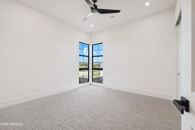 spare room with carpet floors and ceiling fan