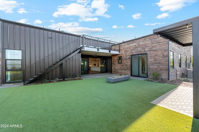 back of house with a yard and a patio area