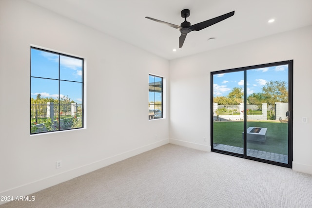 carpeted empty room featuring ceiling fan