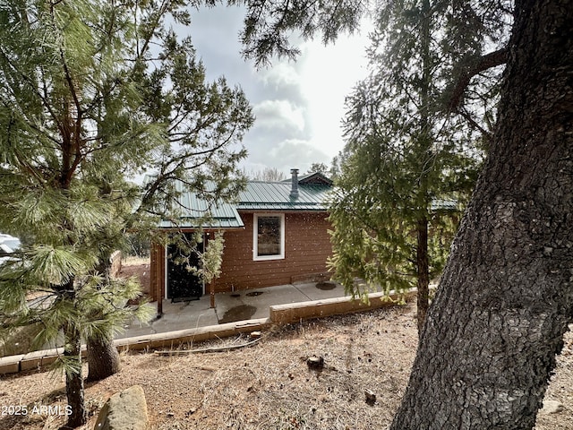 view of side of home featuring a patio