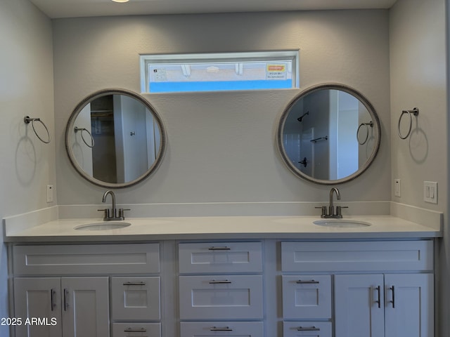 full bathroom featuring a sink and double vanity