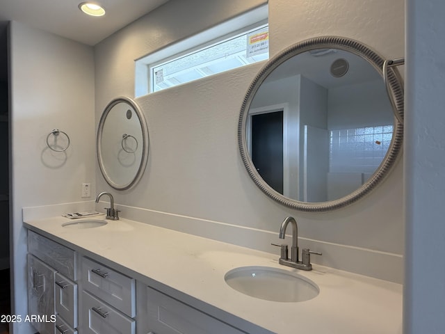full bathroom featuring double vanity and a sink