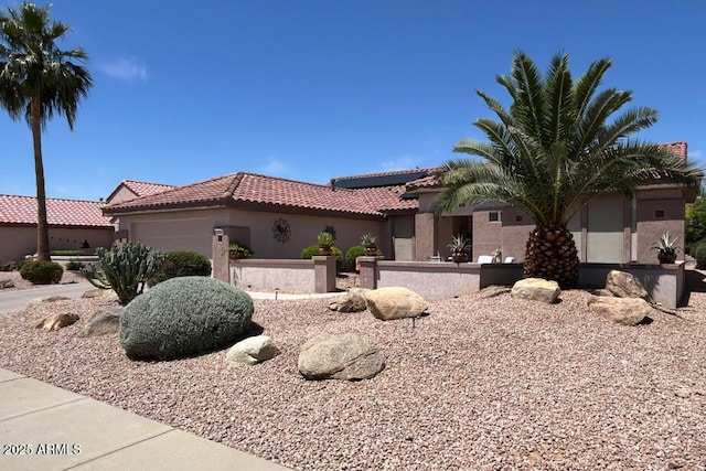 20394 N Coronado Way, Surprise, AZ 85374 - mediterranean / spanish-style house with solar panels, a tiled roof, a garage, and stucco siding