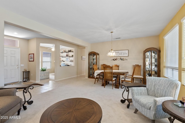 20394 N Coronado Way, Surprise, AZ 85374 - living room featuring light carpet, healthy amount of natural light, and a chandelier