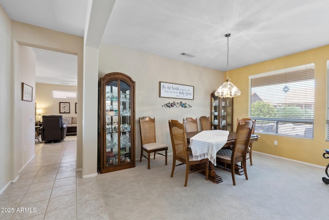 20394 N Coronado Way, Surprise, AZ 85374 - dining area with a chandelier, light carpet, and light tile patterned flooring
