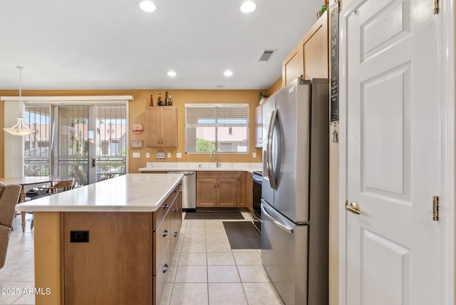 20394 N Coronado Way, Surprise, AZ 85374 - kitchen with appliances with stainless steel finishes, a kitchen island, light tile patterned floors, light countertops, and recessed lighting