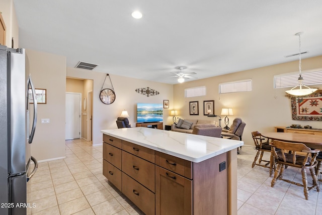 20394 N Coronado Way, Surprise, AZ 85374 - kitchen featuring freestanding refrigerator, light tile patterned flooring, ceiling fan, and open floor plan