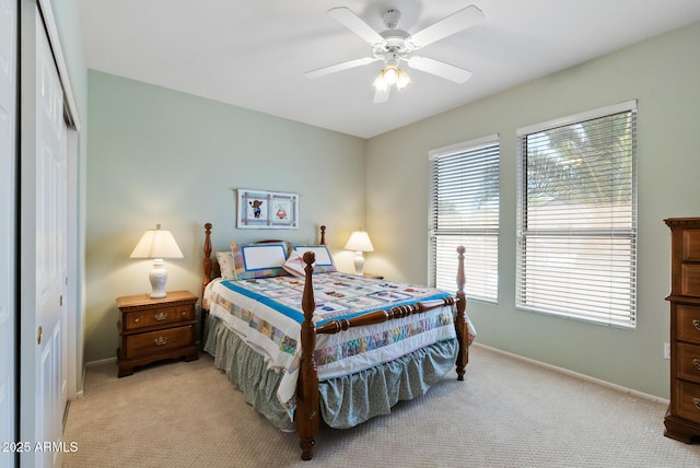 20394 N Coronado Way, Surprise, AZ 85374 - bedroom with light carpet, a closet, and a ceiling fan