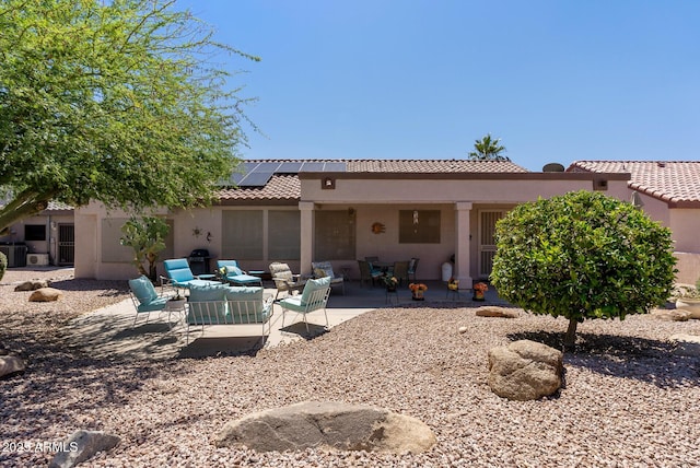 20394 N Coronado Way, Surprise, AZ 85374 - rear view of property featuring an outdoor hangout area, solar panels, a patio, and stucco siding