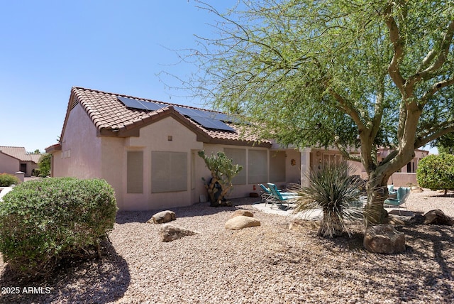 20394 N Coronado Way, Surprise, AZ 85374 - view of front facade with a tile roof, stucco siding, and roof mounted solar panels