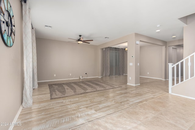 unfurnished living room with ceiling fan and light wood-type flooring