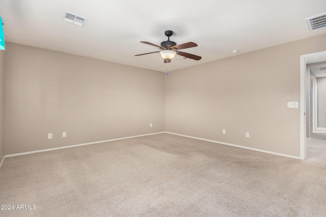 spare room with light carpet and ceiling fan