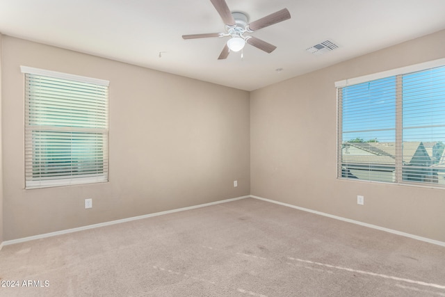 spare room with light colored carpet and ceiling fan