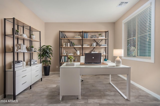 home office with light hardwood / wood-style floors