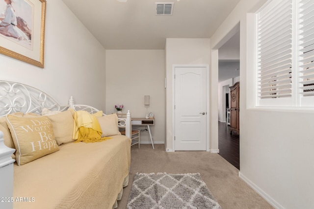 bedroom with baseboards, visible vents, and carpet flooring