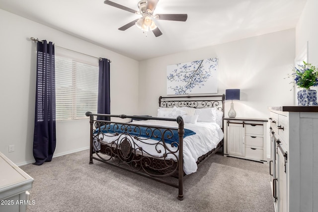 bedroom with light carpet, a ceiling fan, and baseboards