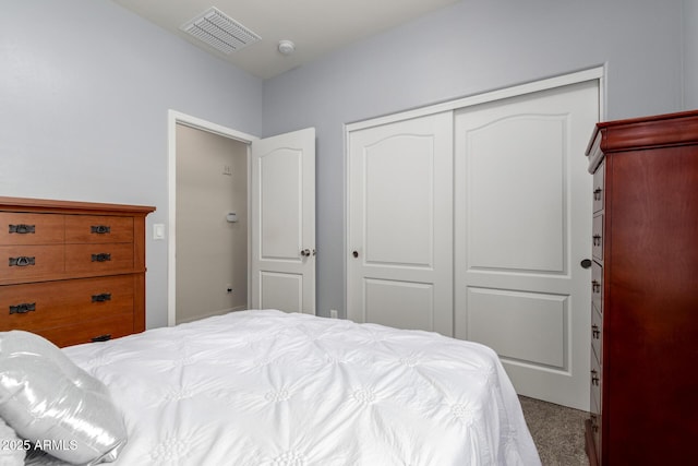 bedroom with carpet floors, a closet, and visible vents