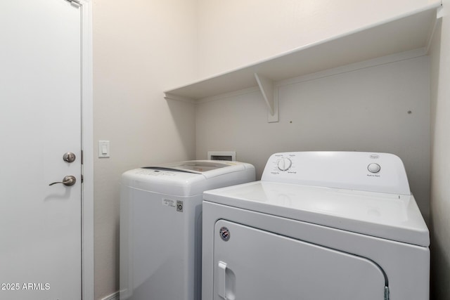 clothes washing area featuring laundry area and separate washer and dryer