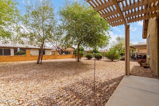 view of yard featuring fence and a pergola