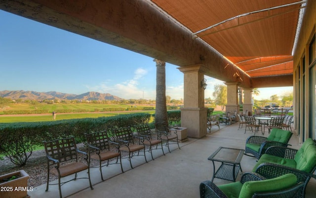 view of patio with outdoor dining area and a mountain view