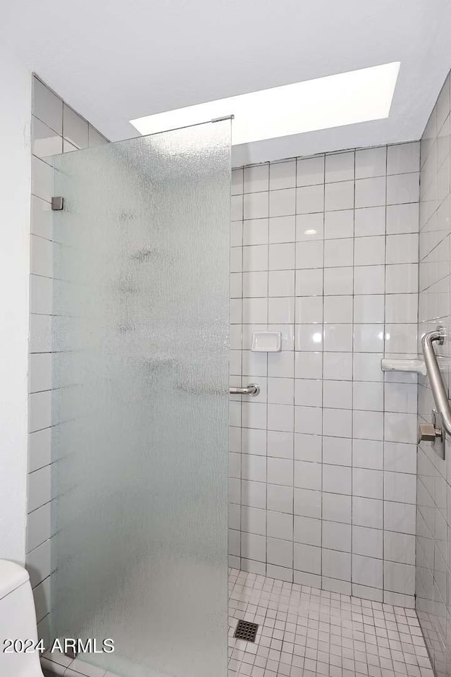 bathroom with a shower with door