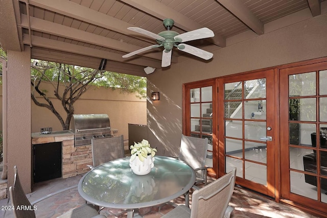 sunroom with beamed ceiling and ceiling fan