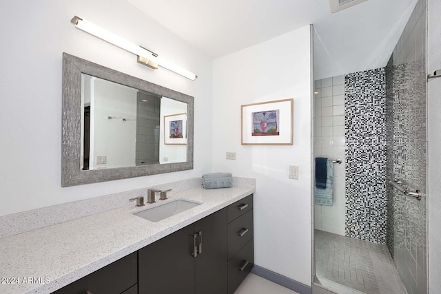 bathroom featuring vanity and a tile shower