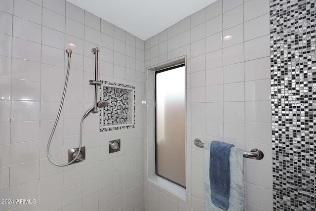 bathroom with a tile shower