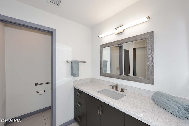 bathroom featuring tile patterned flooring and vanity