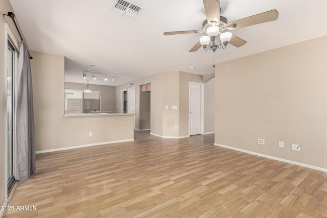 unfurnished living room featuring ceiling fan, visible vents, baseboards, and light wood-style flooring