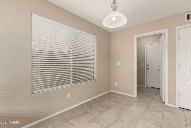 unfurnished room featuring light tile patterned floors, visible vents, and baseboards