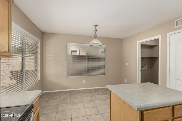 kitchen featuring light countertops, electric stove, baseboards, and pendant lighting