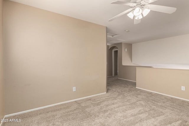 carpeted spare room with baseboards and ceiling fan