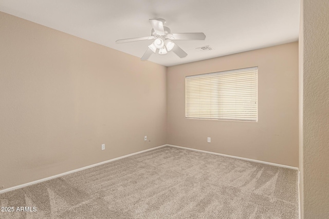 unfurnished room featuring visible vents, baseboards, ceiling fan, and carpet floors