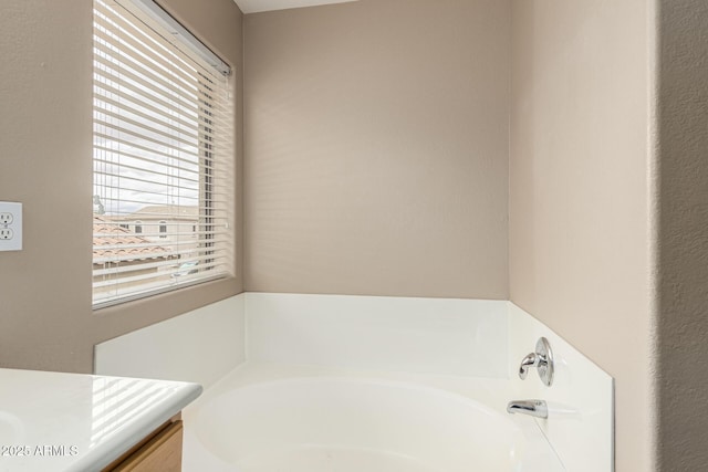 full bath with a garden tub and vanity