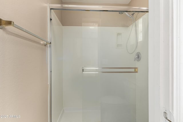 full bath featuring a shower stall